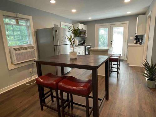 a kitchen with a table and chairs in a room at Cozy Home w/Deck & Fire Pit! in Greensboro