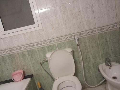 a bathroom with a toilet and a sink at Holiday Trips in Dubai
