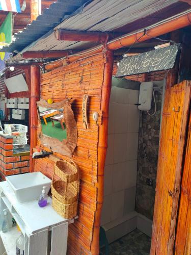 a wooden building with a sink and a table at Wally's House Mancora in Máncora