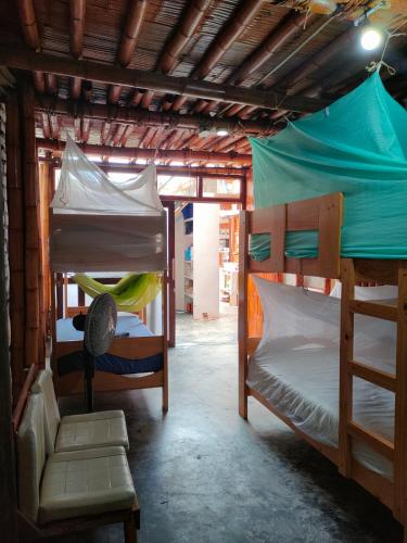 a room with two bunk beds in a building at Wally's House Mancora in Máncora