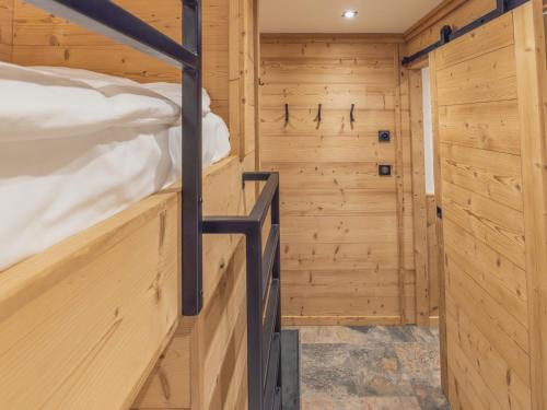 a bedroom with a bunk bed in a wooden room at Appartement Val Thorens, 2 pièces, 5 personnes - FR-1-640-56 in Val Thorens
