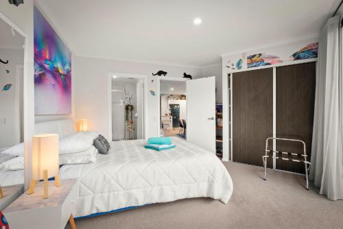 a white bedroom with a large bed and a mirror at Nelson Apartment - 2 Bedroom 2 Bathroom in Sandy Bay