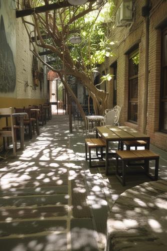 a sidewalk with benches and tables in a building at Pasaje Solar in Buenos Aires
