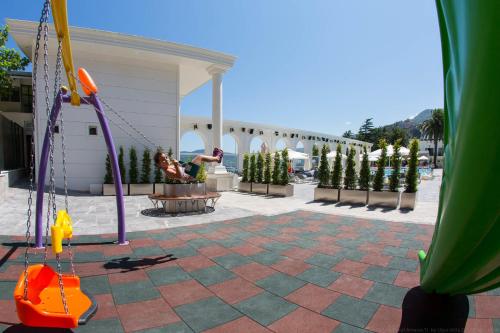 a woman sitting in a swing at a playground at Northdoor Hotel in Amasra