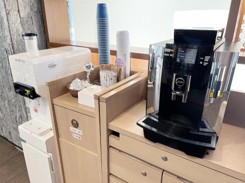 a coffee maker sitting on top of a counter at Hearton Hotel Shinsaibashi Nagahoridouri in Osaka