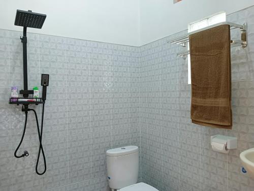 a bathroom with a toilet and a sink at Buda's Homestay Lemukih in Buleleng