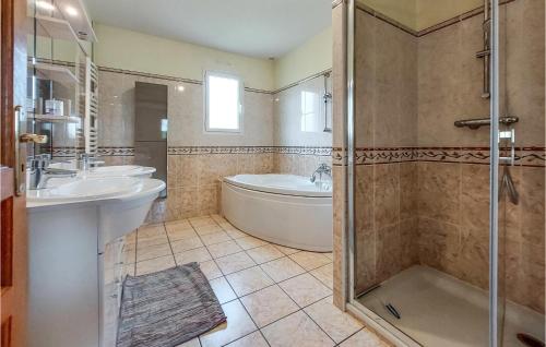 uma casa de banho com 2 lavatórios, uma banheira e um chuveiro em Beautiful Home In St Paer With Kitchen em Saint-Pierre-de-Varengeville