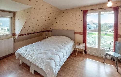 a bedroom with a white bed and a large window at Stunning Home In St Paer With Wifi in Saint-Pierre-de-Varengeville