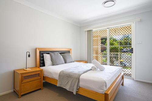 a bedroom with two beds and a large window at DundasParramattatwo-level 3Br HouseWiFi&Parking in Sydney