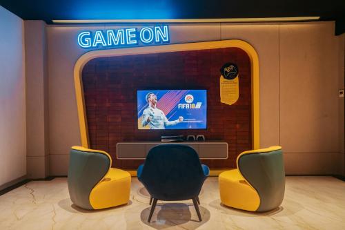 a game room with two chairs and a tv at Yello Hotel Harbour Bay in Nagoya