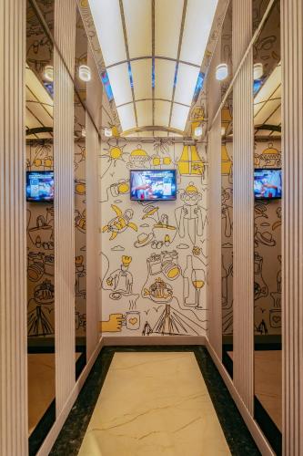 a hallway with a wall covered in graffiti at Yello Hotel Harbour Bay in Nagoya