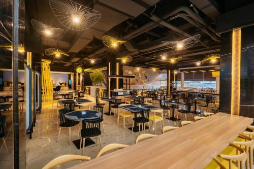 a restaurant with tables and chairs in a room at Yello Hotel Harbour Bay in Nagoya