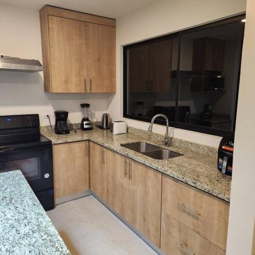 a kitchen with a sink and a counter top at Casa Bellota in Marbella