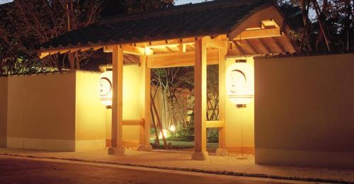 a building with a pavilion on a street at night at Ryokan Imai in Shibata