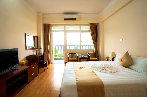 a hotel room with a large bed and a television at PSA Nghi Sơn Condotel in Thanh Hóa