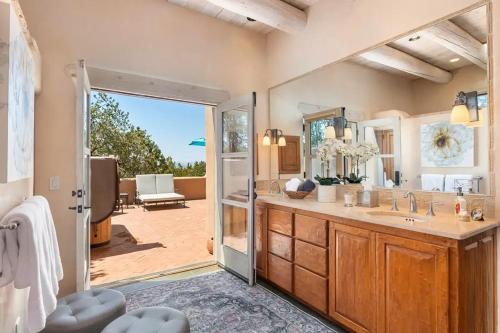a bathroom with a sink and a mirror at Villa Namaste-Mountain View Home in Santa Fe