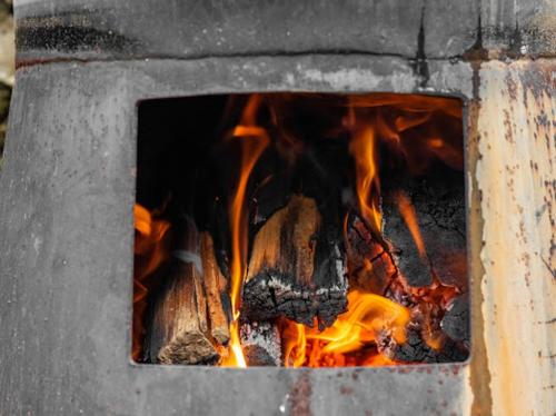 a brick oven with a fire in it at Diamond Vault Rustic Mountain Cabins in Hogsback