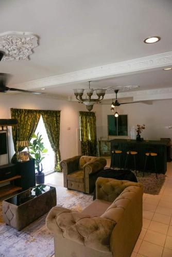 a large living room with couches and a kitchen at Homestay Country Homes Rawang in Rawang