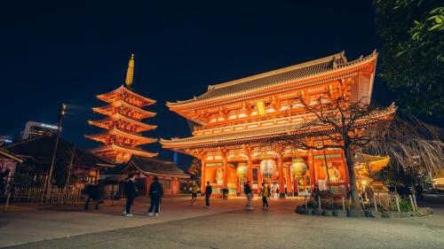 a large building with people walking in front of it at Toyoko Inn Yashio Ekimae in Yashio