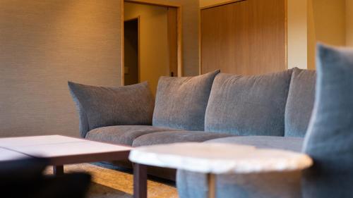 a living room with a couch and a table at Sengokubara COCON in Hakone