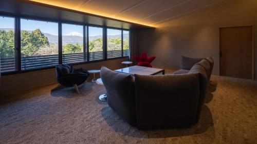a living room with a couch and chairs and a table at Sengokubara COCON in Hakone