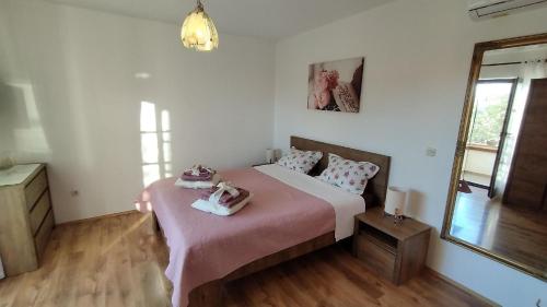 um quarto com uma cama com lençóis cor-de-rosa e um espelho em Studio für 2 Personen ca 25 qm in Novigrad, Istrien Istrische Riviera - b44338 em Karpinjan