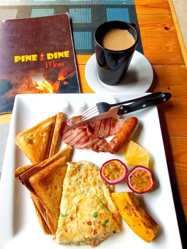 a plate of breakfast food with a cup of coffee at Koselig Homes in Nanyuki