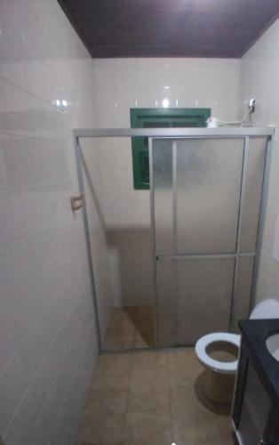 a bathroom with a shower with a toilet and a sink at B & B HOSTEL Coqueiros in Florianópolis