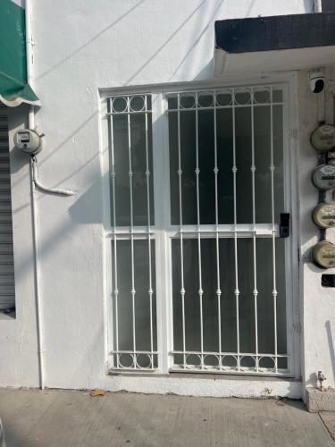 a door with a gate on the side of a building at Loft Jardines in Tuxtla Gutiérrez