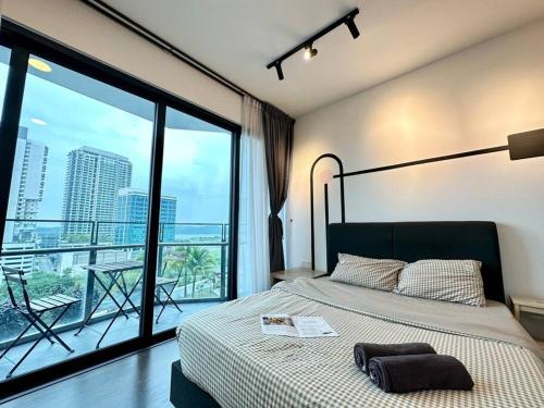 a bedroom with a bed and a large window at Almas Suites Studio Netflix Puteri Harbour By STAY in Nusajaya