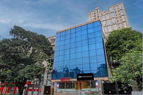 a tall glass building with a sign on it at Townhouse Refresh in Kolkata
