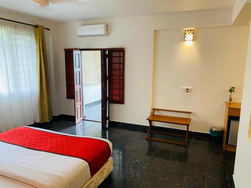 een slaapkamer met een bed en een tafel. bij Peppervine Hotel in Thekkady