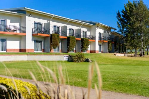 a building with a lawn in front of it at Springs Shoalhaven Nowra in Nowra