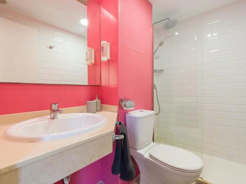 a bathroom with a sink and a toilet and a mirror at Casa Tindaya - 5 min walk from the Sea in Corralejo