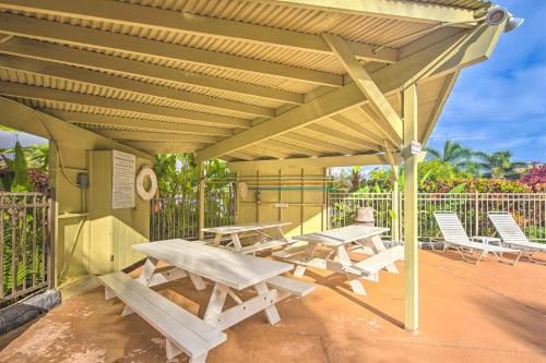 a picnic table and chairs under a wooden pergola at Kapa`a Sands 18 in Kapaa