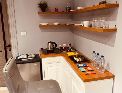 a kitchen with a counter with a sink and a stove at Rove Residence New Cairo in Cairo