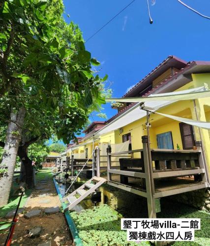 a house with a fence in front of it at 墾丁牧場Villa Kenting Pasture - Villa B&B in Kenting