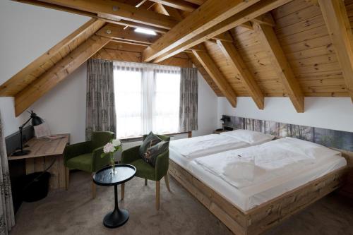 a bedroom with a bed and a desk and a computer at Landhotel Gasthof Krone in Kupferzell