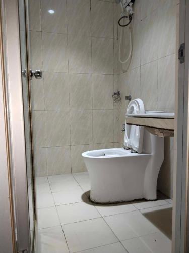 a bathroom with a shower and a toilet and a sink at Meaco Royal Hotel - Valenzuela in Subusub