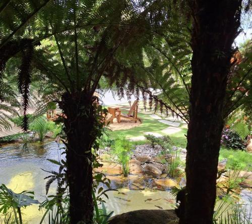 a painting of a pond in a garden with trees at Afha 48 in Monte Verde