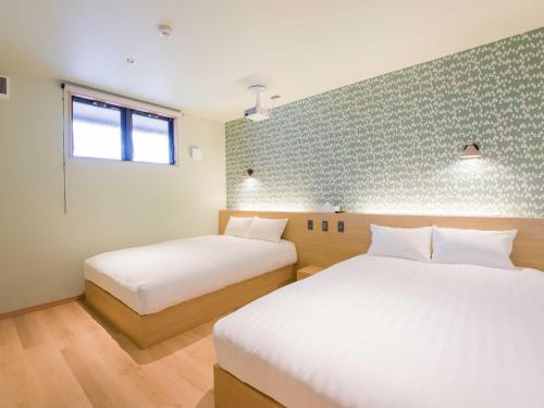 a room with two beds and a window at Rakuten STAY VILLA Nasu in Nasu