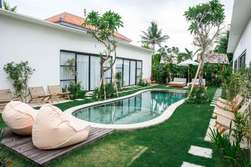 a swimming pool in the yard of a house at Shanti Boutique Retreat in Tanah Lot