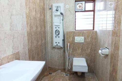 a bathroom with a shower and a toilet at 4BHK Luxury Apartment at VV Mohalla/Mysore by Revkeys in Mysore