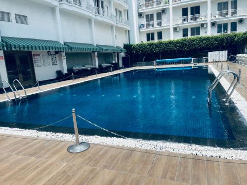 a large blue swimming pool in front of a building at The Royal Residency Suites,Lucknow Gomti Nagar in Lucknow