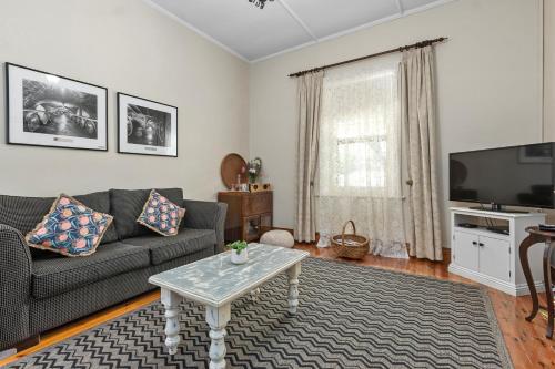 a living room with a couch and a coffee table at Miriams Cottage in Tanunda