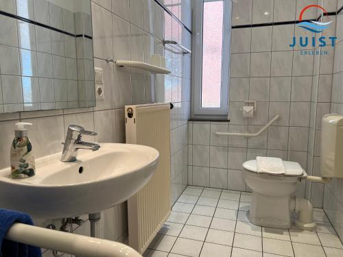 y baño con lavabo y aseo. en Pension Marie Luise 251 - Zimmer Herzmuschel en Juist