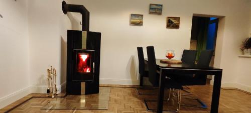 a wood burning stove in a room with a table at Modernes Wohnen am See in Schwerin