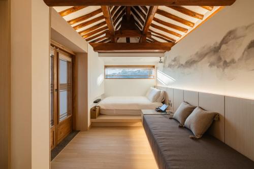 a room with a couch and a bed in it at Luxury hanok with private bathtub - SN18 in Seoul