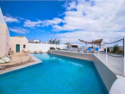 una gran piscina azul en una casa en OMIROS HOTEL en Mesariá