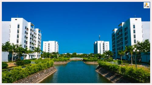 a river in the middle of a city with tall buildings at PSA Nghi Sơn Condotel in Thanh Hóa